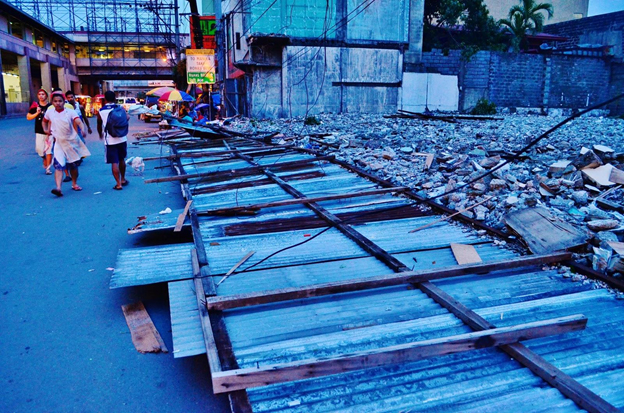 Winds of up to 160 kph brought significant destruction in areas affected by Supertyphoon Glenda, including Metro Manila. A fence made from sheets of metal roofing lay toppled on a sidewalk along EDSA hours after the storm passed over the metropolis in July. Toby Roca/UP Journalism Club