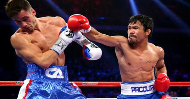 Pacquiao throws an overhand punch disorienting Algieri during their WBO welterweight title fight on Nov. 23 in Macau. (Photo by: L.A. Times) 